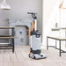 Nilfisk SC100 upright scrubber dryer cleaning wooden floors in a café setting with natural daylight.