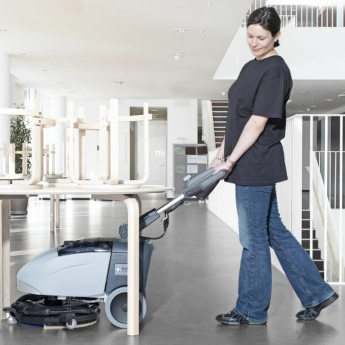 Compact Nilfisk SC351 walk-behind floor scrubber dryer ideal for offices, retail, and small facilities