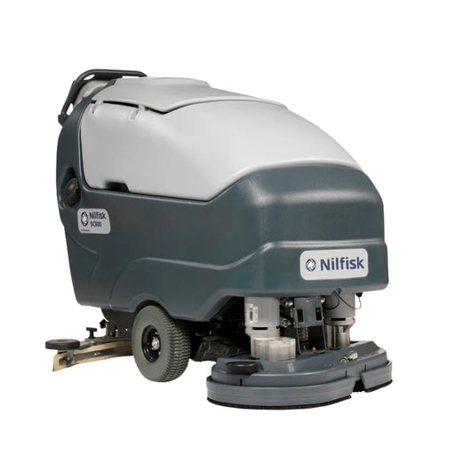Operator using Nilfisk SC800 71 large walk-behind scrubber dryer for efficient wide-area floor maintenance