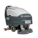 Operator using Nilfisk SC800 71 large walk-behind scrubber dryer for efficient wide-area floor maintenance