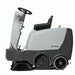 Operator driving Nilfisk SR1000S mid-size ride-on battery powered sweeper delivering powerful cleaning for indoor and outdoor spaces