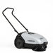 Operator using Nilfisk SW750 battery operated walk-behind floor sweeper for reliable cleaning in commercial and industrial facilities